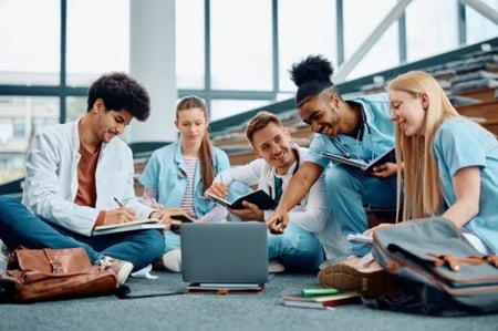 group-of-happy-medical-students-using-laptop-while-2023-11-27-05-34-43-utc182